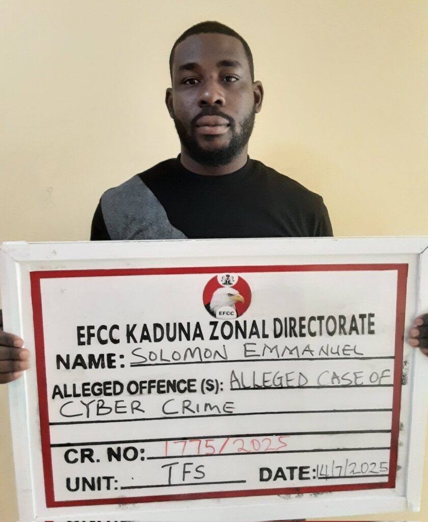 The fraudster holding a placard